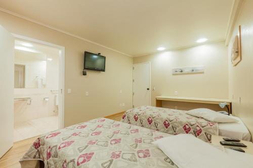 Tri Hotel Smart Caxiasにあるベッド