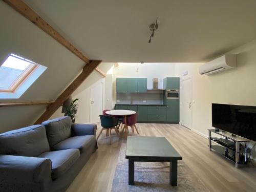 a living room with a couch and a table at B&B Vrijheid 4 in Arendonk