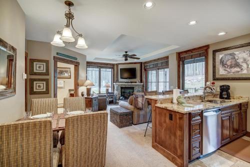 a kitchen and living room with a table and chairs at True Ski-in Ski-out Luxury Condo on Peak 7 condo in Breckenridge