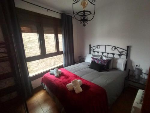 Un dormitorio con una cama con dos ositos de peluche. en Cal Massana, en Sant Guim de la Plana