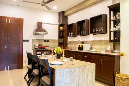 a kitchen with a large wooden table and chairs at Cinnamon Tan Boutique Hotel in Negombo