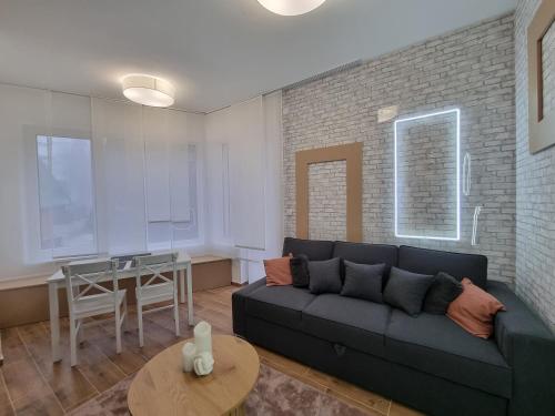 a living room with a couch and a table at Nivalis Hill N&V in Jahorina