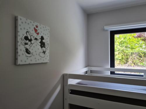 a bedroom with a bed and a window at Villa Stijn in Middelkerke