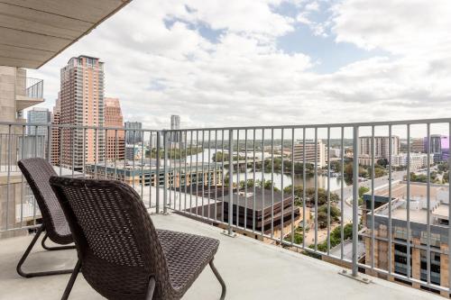 a balcony with two chairs and a view of a city at Kasa 2nd Street Austin in Austin