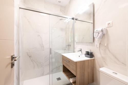 a bathroom with a shower and a sink at Hotel Adeje Plaza in Adeje