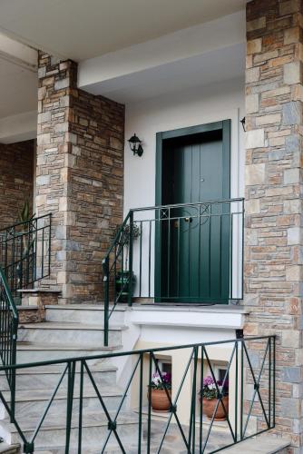 a front door of a house with a green door at Volos luxury maisonette-Pelion view in Volos