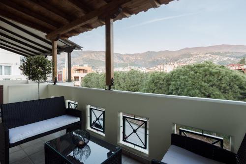 a balcony with a couch and a table at Volos luxury maisonette-Pelion view in Volos