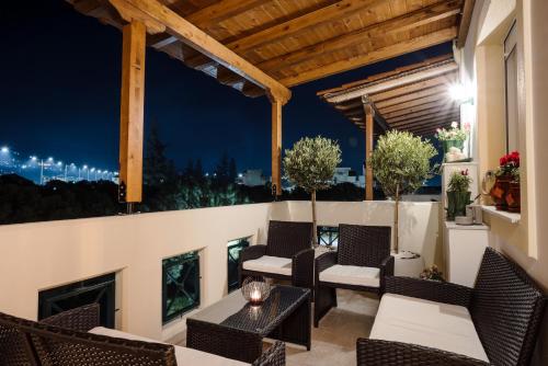 a patio with chairs and a fireplace at night at Volos luxury maisonette-Pelion view in Volos