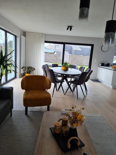 a living room with a table and chairs at Villa Stijn in Middelkerke