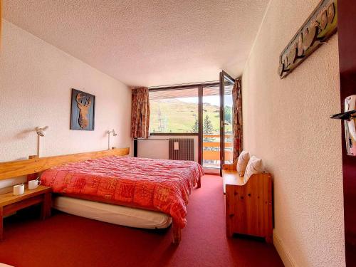 a hotel room with a bed and a large window at Appartement Les Menuires, 2 pièces, 4 personnes - FR-1-344-1002 in Les Menuires