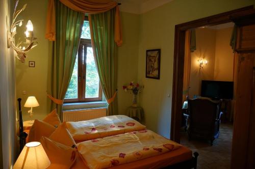 a bedroom with two beds and a window at Hotel Villa Herzog in Dresden