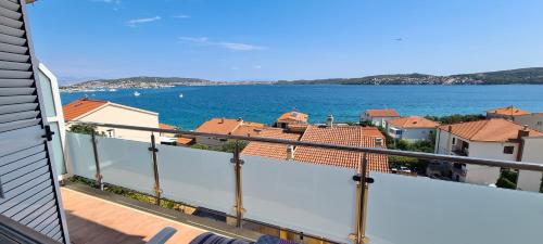 a balcony with a view of the water and buildings at Apartmani Gizela in Trogir