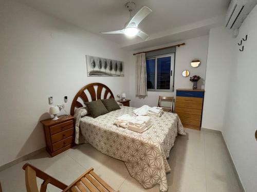a bedroom with a bed and a dresser and a window at Villa Hortensia - Primera linea playa la concha in Oropesa del Mar