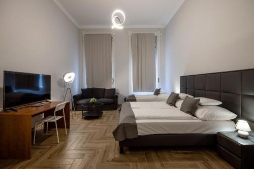 a bedroom with a bed and a flat screen tv at Prime Time Vaci Budapest in Budapest