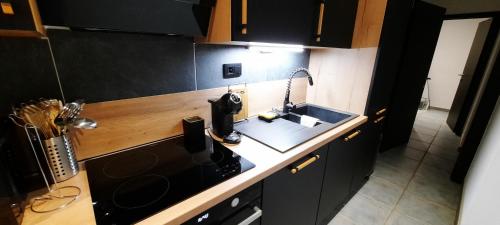 a kitchen with a sink and a counter top at Nez sur la croisette. in Dinant