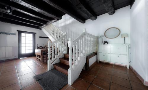 a white staircase in a room with a mirror at Relax, montaña, paz in Errezil