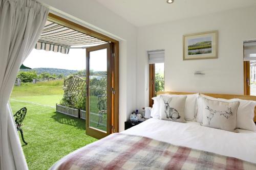 a bedroom with a bed and a large window at Exclusive Use of A Barn in Arundel