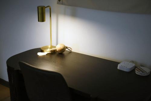 a table with a lamp on top of it at HostWise Stays - Butler St, Lower Lawrenceville, Brand New! in Pittsburgh