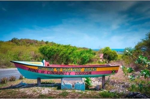 a boat on display on the side of a road at Brytan Villa in Treasure Beach