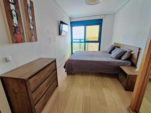 a bedroom with a bed and a large window at Vista al Mar, Ferienwohnung, Traumhafter Meerblick, Seaview in Torrevieja