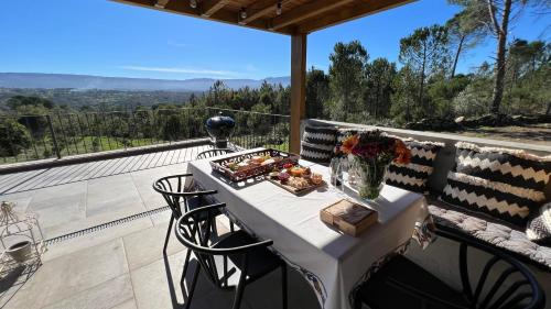 a table with a plate of food on a balcony at Casas do Pinheiro Grande in Fornos de Algodres
