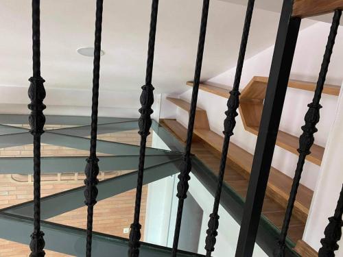 a glass staircase in a house with black railings at Bakuriani Fun, nice view and design, cosy and spacious in Bakuriani