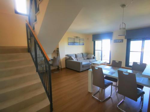 a living room with a table and a couch at Apartamento Golf PANORAMICA in Sant Jordi