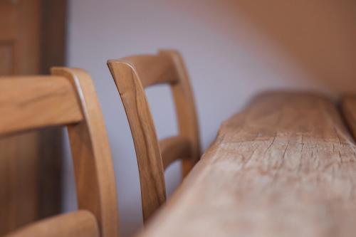 a wooden table with two chairs in a room at Guesthouse Novak in Dvor