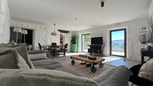 a living room with a couch and a table at Casas do Pinheiro Grande in Fornos de Algodres