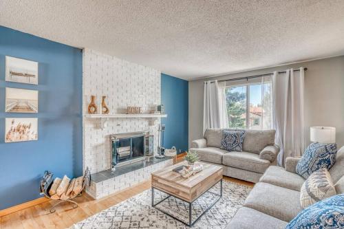 a living room with a couch and a fireplace at Boho Retreat w/King Bed on Bow River Pathway in Calgary