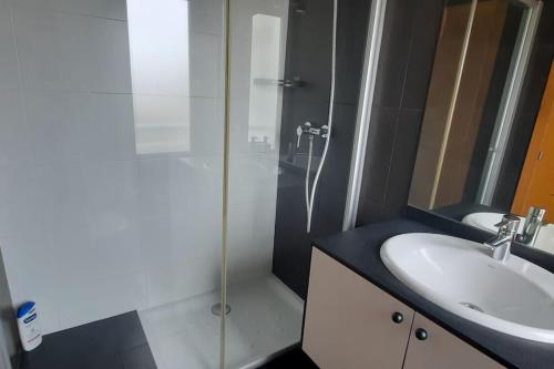 a bathroom with a sink and a glass shower at Luz de Vigo in Vigo