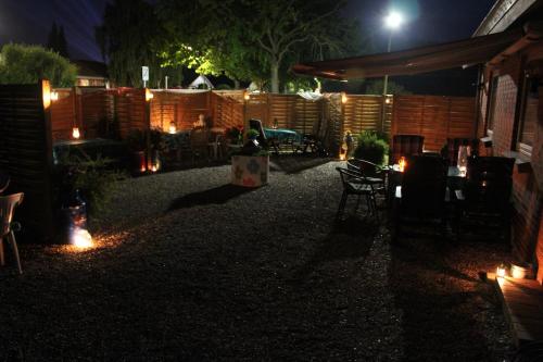 a backyard at night with lights and a fence at Hine Bakke Bed And Breakfast in Rudkøbing