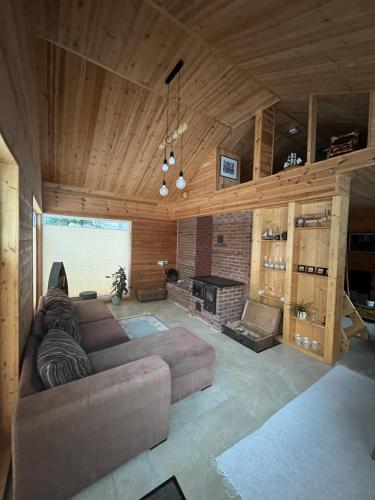 a living room with a couch and a fireplace at Sisaliku Puhkemaja saunaga in Luke