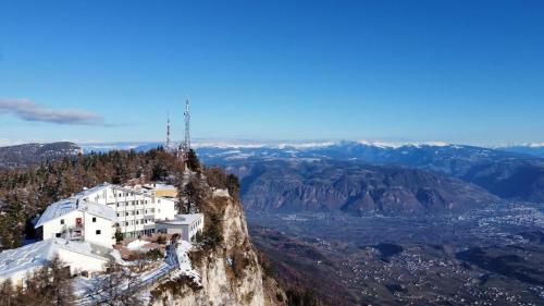 a building on the side of a mountain at PanoramaHotel Penegal in Mendola