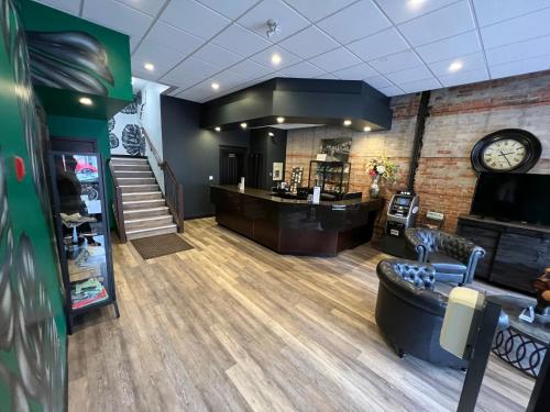 a waiting area of a hair salon with a clock at Commercial Hotel in Edmonton