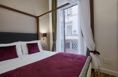 a bedroom with a large bed and a window at L'obelisque maison de luxe in Rome