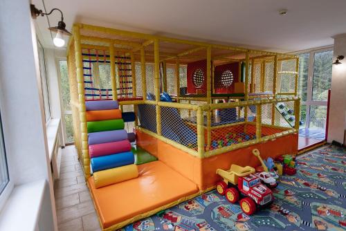 a play room with a toy truck and a slide at Highland in Yablunytsya
