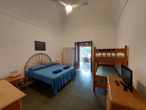 a bedroom with a bed and a bunk bed at Casa Gelsomino in Favignana