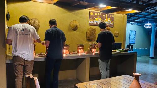 a group of men standing around a counter in a museum at Nature House in Udawalawe