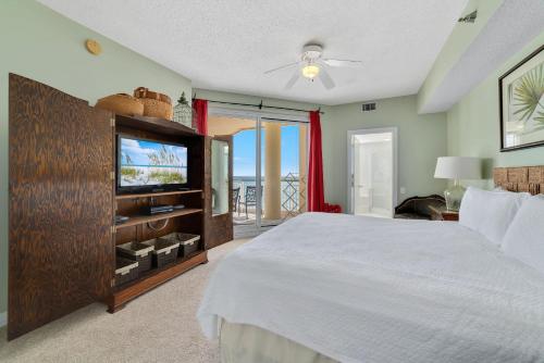 a bedroom with a large bed and a television at Beach Colony Tower 12B in Perdido Key
