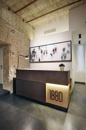 a lobby with a reception desk in a brick wall at Hotel Giolli Nazionale in Rome