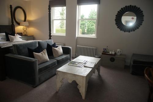 a living room with a couch and a coffee table at Beechfield House in Beanacre