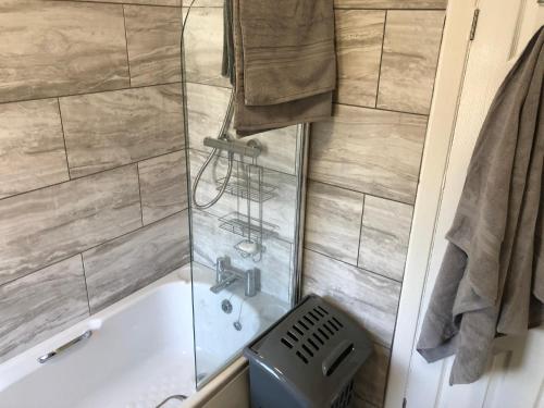 a bathroom with a shower with a tub and a sink at Angie’s hideaway in Balby