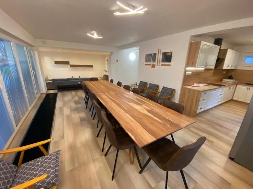 a long wooden table and chairs in a room at Residence Dymokury in Dymokury