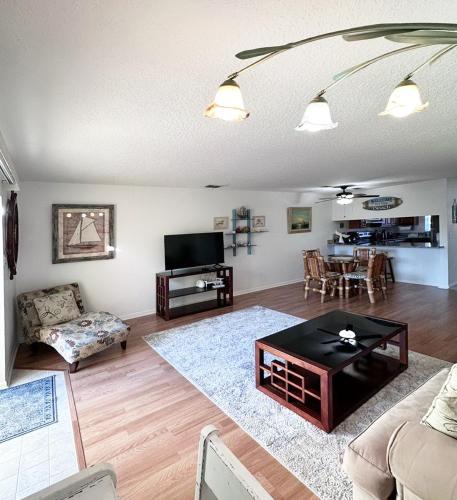 a living room with a couch and a table at The Ultimate Beach Getaway in Cape Canaveral
