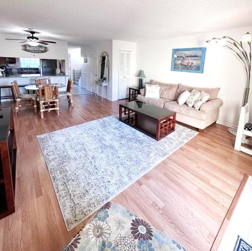 a living room with a couch and a table at The Ultimate Beach Getaway in Cape Canaveral