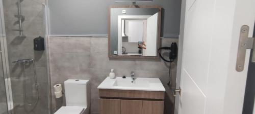 a person taking a picture of a bathroom at Apartamentos Las trece llaves Jacuzzi bajo reserva in Merida