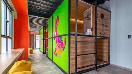 a room with a green and orange wall at Barrio Downtown Mexico City Hostel in Mexico City