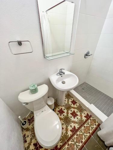 a bathroom with a toilet and a sink at Nando's Place in San Juan