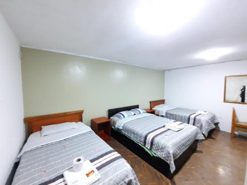 Ένα ή περισσότερα κρεβάτια σε δωμάτιο στο Hostal Dulzura